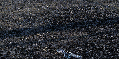 Stone chips melted on road due to high temperature in summer.