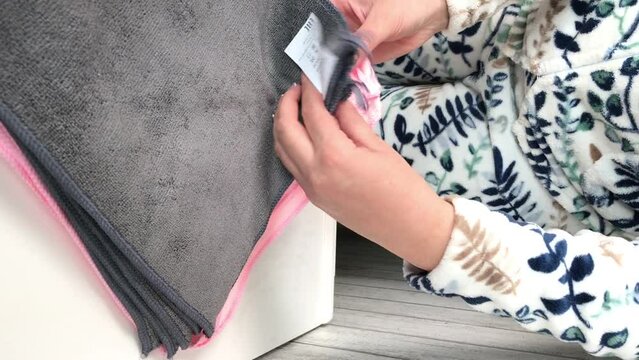 Microfiber cleaning cloth.  The woman demonstrates their functions and use. Vertical video.