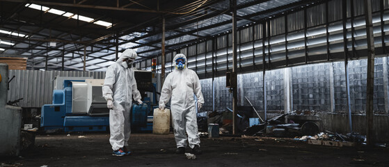 Workers in protective suits inspect chemicals in an old factory, safeguarding against hazards and contamination. This is part of an emergency response to a radioactive accident. - obrazy, fototapety, plakaty