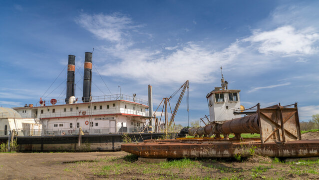 Brownville, NE, USA - April 19, 2024:  Historic river dredge, Captain Meriwether Lewis, in a dry dock on a shore of Missouri River.