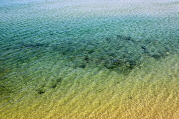 The color of water in the Mediterranean Sea in shallow water. Natural abstract background.