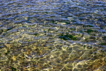 The color of water in the Mediterranean Sea in shallow water. Natural abstract background.