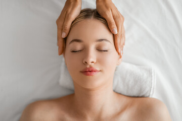 Serene Woman Enjoying a Relaxing Head Massage at a Spa