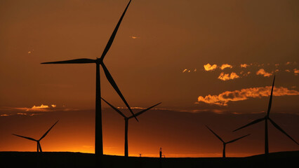 Windmills or wind turbine in sunrise light