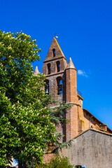 Fototapeta premium Clocher à l’architecture caractéristique en briques rouges de l’Eglise Saint-Martin de Nailloux, dans le Lauragais, près de Toulouse