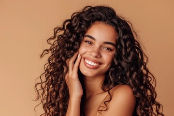 Hair care, grin, and studio portrait of woman with salon curl keratin treatment. Makeup, cosmetics, and headshot of Indian female model with long, lustrous, clean hair on brown background.