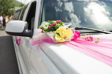 White wedding limousine with flowers