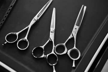 Three pairs of hairdressing scissors - obrazy, fototapety, plakaty