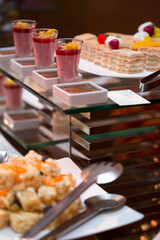 Canapes on wrapped skewers with tomato