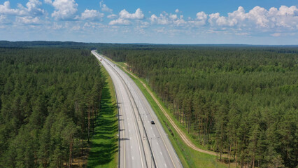 Aerial top view on country road in forest