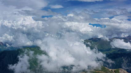 Caucasus mountains and town under clouds