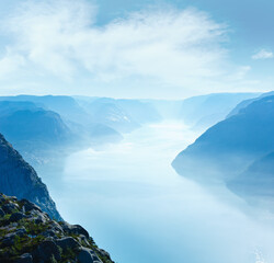 Summer morning misty view from Preikestolen massive cliff top (Norway, Lysefjorden)