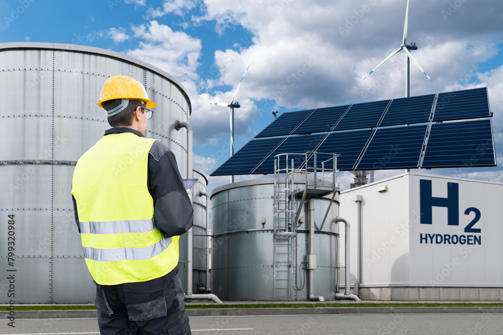 Poster Engineer with tablet computer on a background of Hydrogen factory.