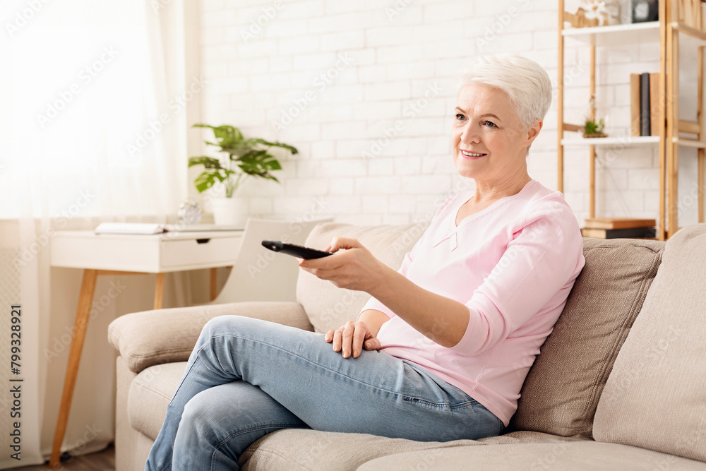 Canvas Prints Senior Woman Sitting on Couch Holding Remote Control