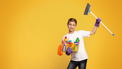 Young Boy Holding Broom and Basket of Toys