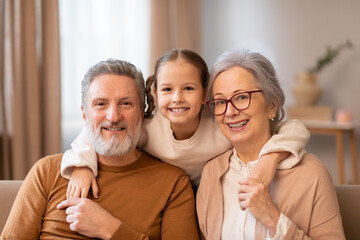 Man, Woman, and Child Sitting on a Couch, Smiling