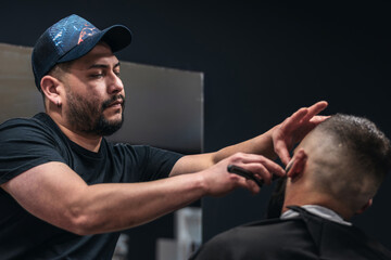 A barber shaves a man's beard. The barber uses a straight razor to shave the man's beard - Powered by Adobe