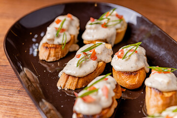 Open your mouth, garlic bread with acevichada sauce in the foreground.
