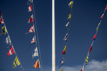Nautical flags fluttering in the wind. Colorful signal flags