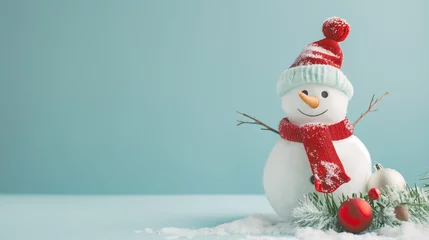 Fotobehang Christmas and New Year banner with a cute snowman in a red scarf on a light blue background and copy space © Apalko