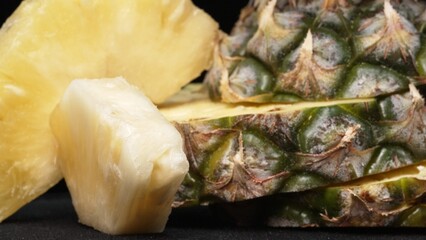 Close up video of fresh pineapple with slice of peel pineapple insert with separated black...