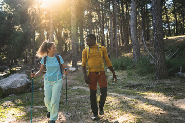 Smiling Couple Hiking Together in Sunlit Forest