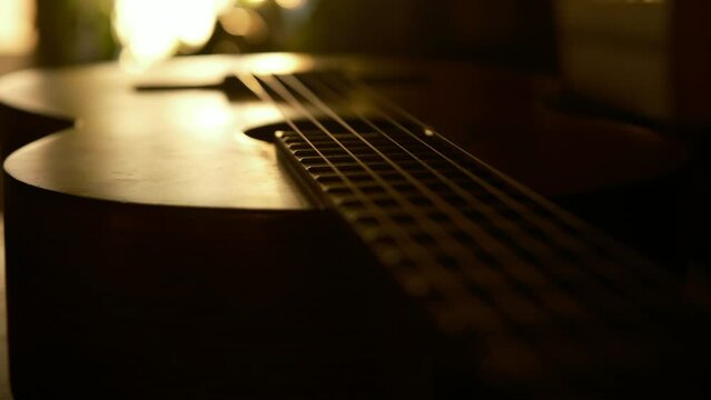 cinematic, classical guitar in the rays of the setting sun, sunset color 4k slow motion. music lifestyle