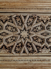 Carved antique wooden doors with patterns and mosaics.