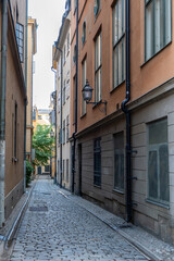 Sweden Stockholm traditional building, lantern, empty narrow alley, Gamla Stan Old Town. Vertical