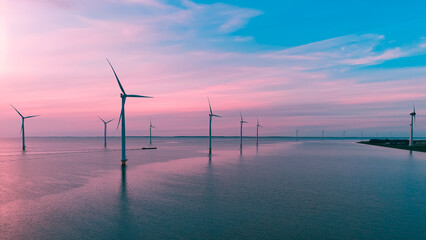 Aerial drone view wind turbine park ofsshore wind farm in the Netherlands on sunset.