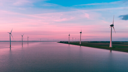 Aerial drone view wind turbine park ofsshore wind farm in the Netherlands on sunset.