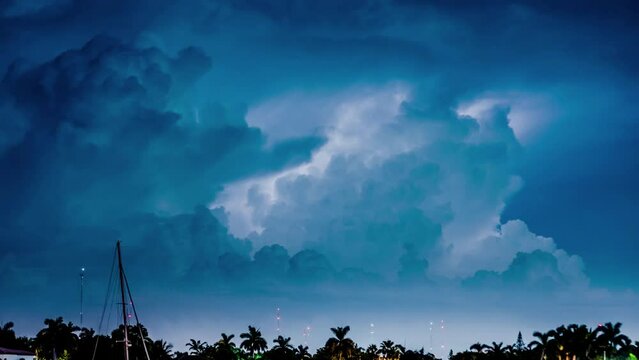 Thunderstorm clouds, lightning bolts over stormy marina skyline in Miami, Florida. 4K Timelapse.