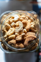 Glass jar filled with cashews on table