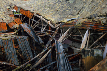 Destroyed industrial building. Insulated roof structures of an industrial building after fire and collapsing. - 799366733