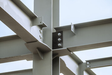 Mounting bolted connection of steel beams before welding. Metal construction covered protective...