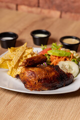 Peruvian grilled chicken, with fries and salad.