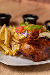 Peruvian grilled chicken, with fries and salad.