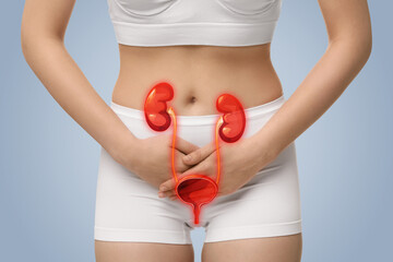 Woman suffering from cystitis on light blue background, closeup. Illustration of urinary system