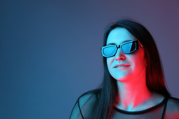 Portrait of beautiful young woman with sunglasses on color background. Space for text