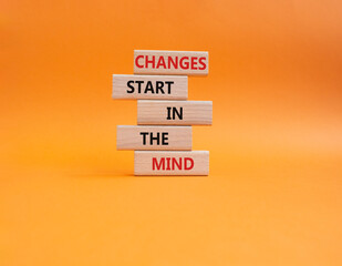 Changes start in the Mind symbol. Wooden blocks with words Changes start in the Mind. Beautiful orange background. Business and Changes start in the Mind concept. Copy space.
