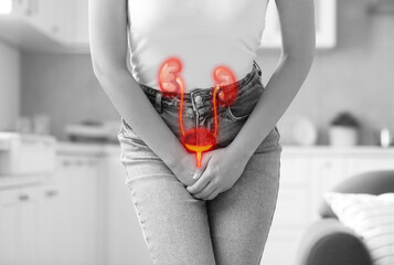 Woman suffering from cystitis at home, closeup. Illustration of urinary system