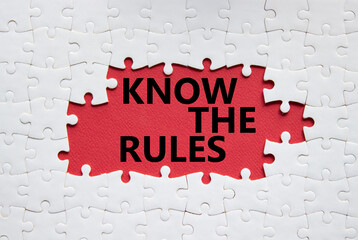 Know the rules symbol. Concept words Know the rules on white puzzle. Beautiful red background....