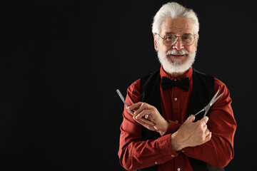 Senior man with mustache holding blade and scissors on black background, space for text