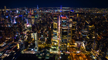 Naklejka premium Night scenery of New York, the USA with fantastic illumination. Skyscrapers in the scenery of metropolis are dazzling and sparkling with lights. Top view.