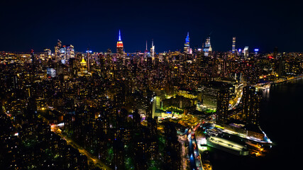 Amazing view of New York at dusk. Approaching spectacular skyscrapers with neon illumination. Top...