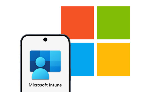 Microsoft Intune logo displayed on a modern smartphone standing on a desk, Microsoft logo behind it, cloud-based unified endpoint management service, Microsoft Azure