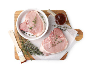 Board with raw meat, thyme, basting brush and marinade isolated on white, top view