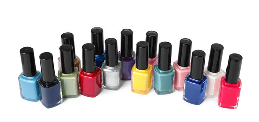 Obraz premium Bright nail polishes in bottles isolated on white