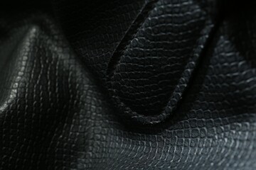 Black natural leather as background, closeup view