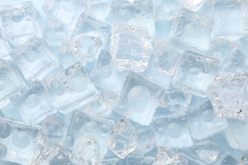 Crystal clear ice cubes on light blue background, flat lay